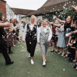 Mrs and Mrs walking through their confetti shot at their hotel wedding venue.