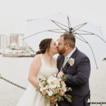 Wedding shot in the rain at Ipswich waterfront outside Isaacs quay